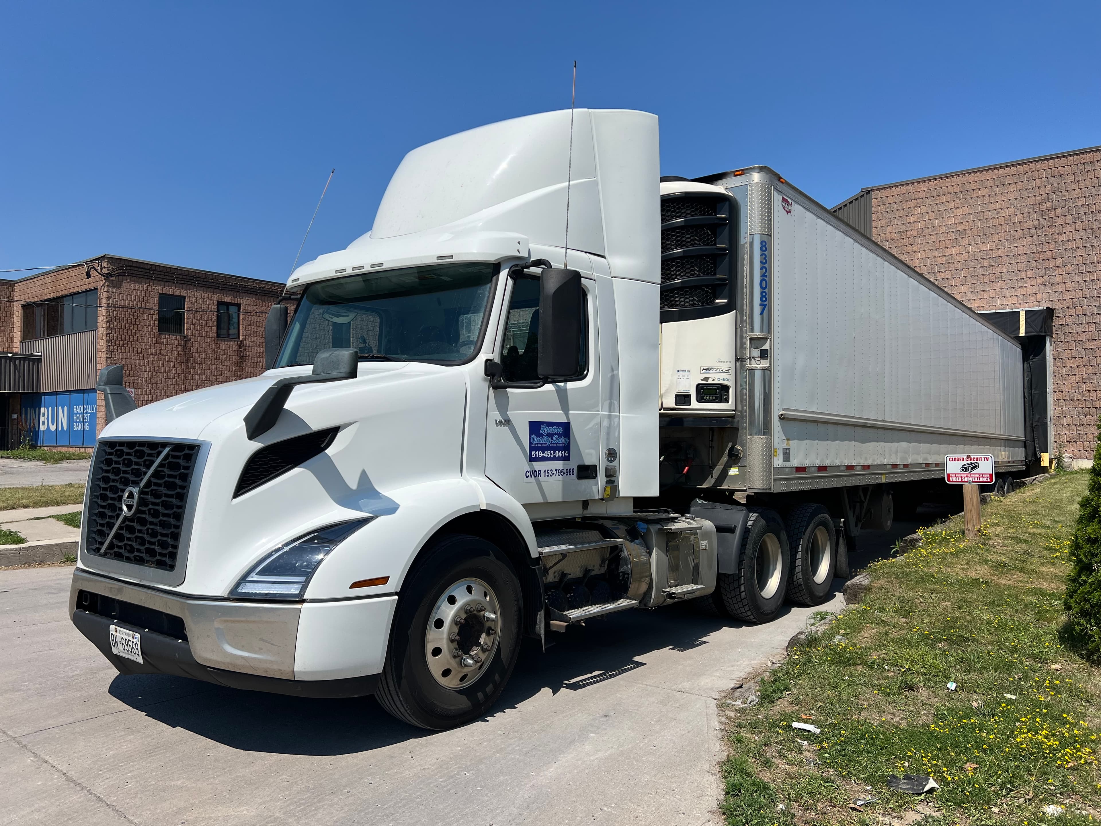 A London Quality Dairy tractor trailer backed into the loading dock at the company's facility.